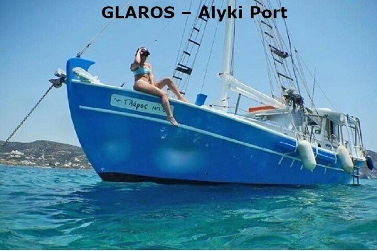 a woman sitting on a blue boat in the water