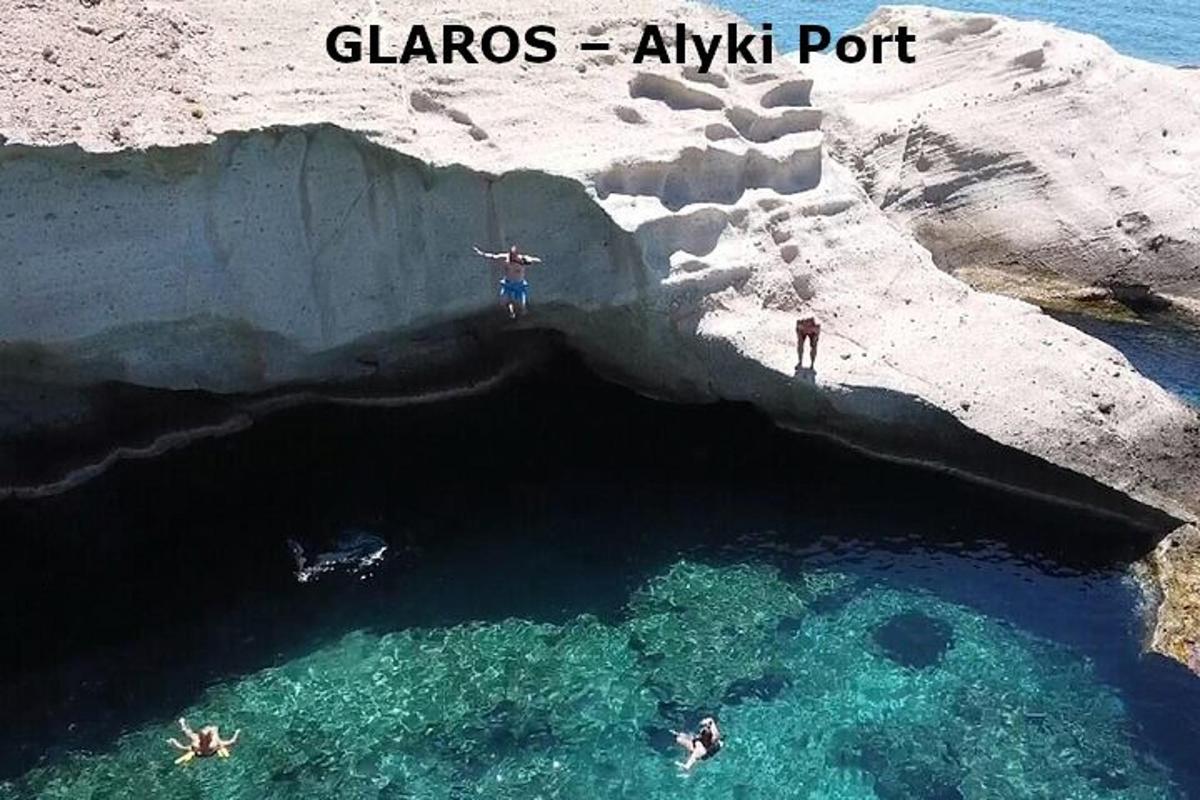 a group of people swimming in a cave in the water
