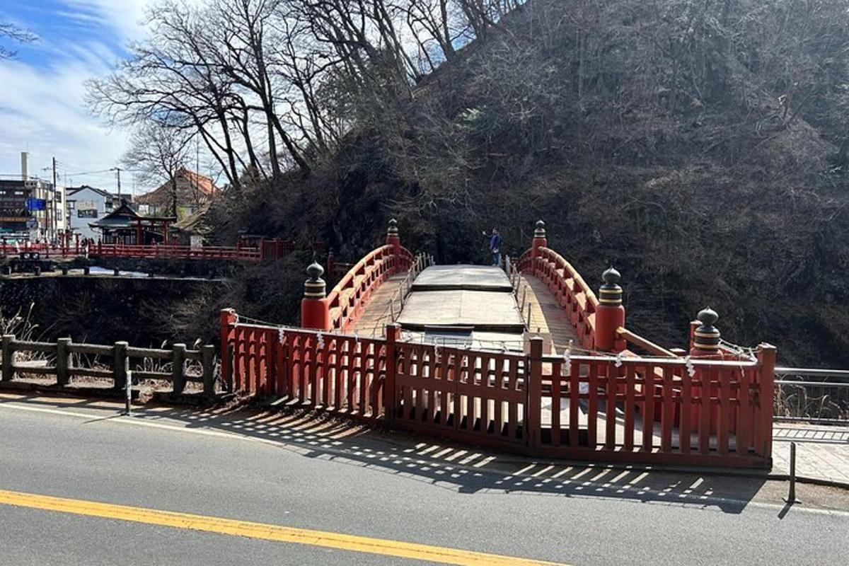 a bridge with an orange fence on the side of a road