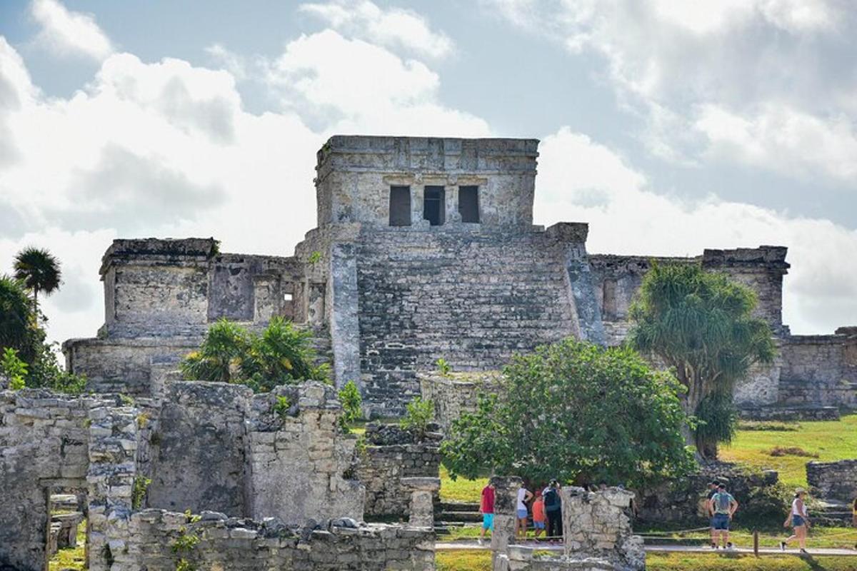 people standing in front of a stone building