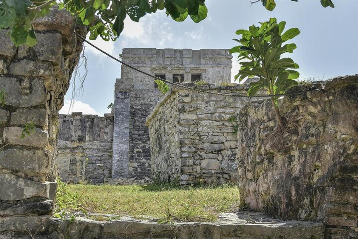 an old stone wall with a building in the background