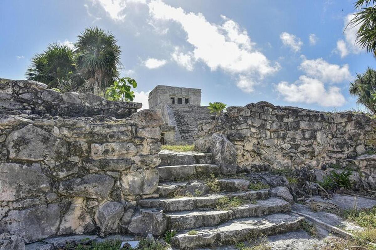 a stone wall with stairs in front of a building