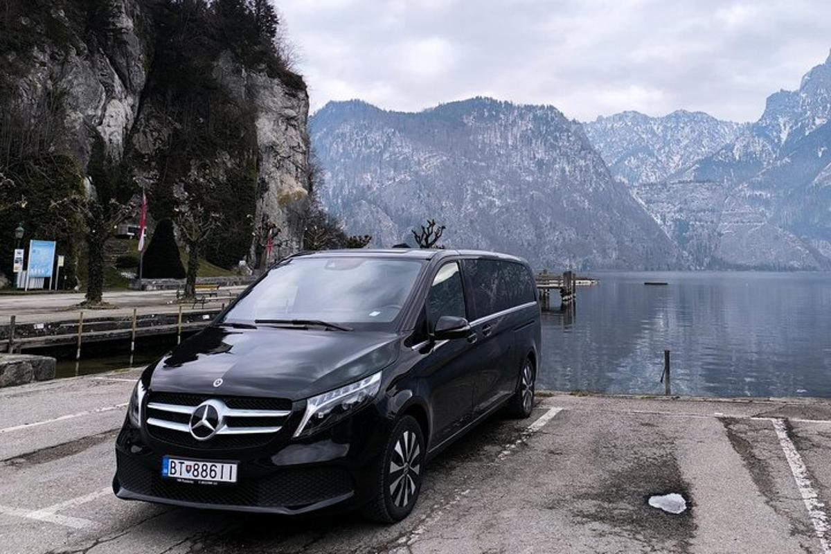 un'auto nera parcheggiata accanto a uno specchio d'acqua