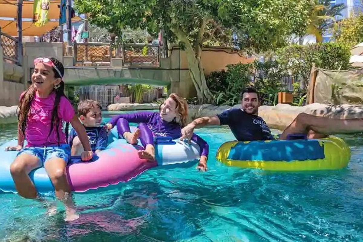 a group of people in the water at a pool