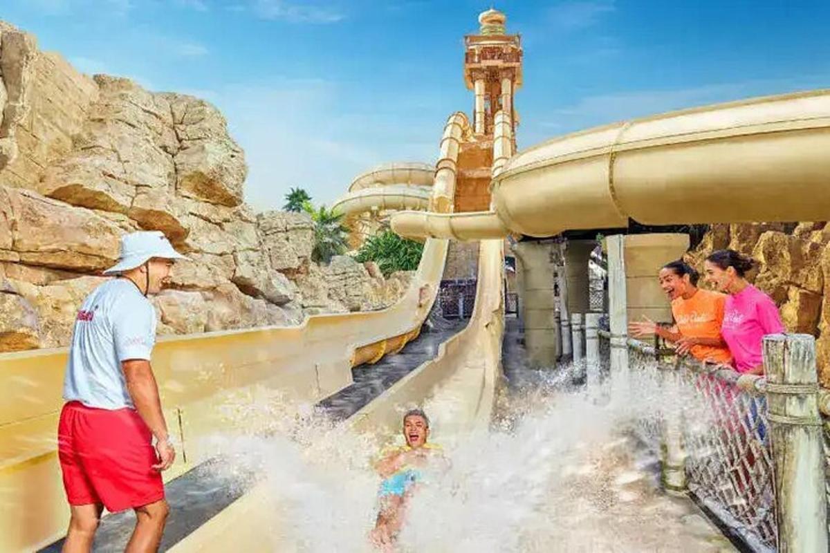 a group of people playing in a water slide at a water park
