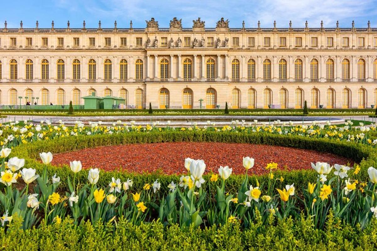 a garden of flowers in front of a building