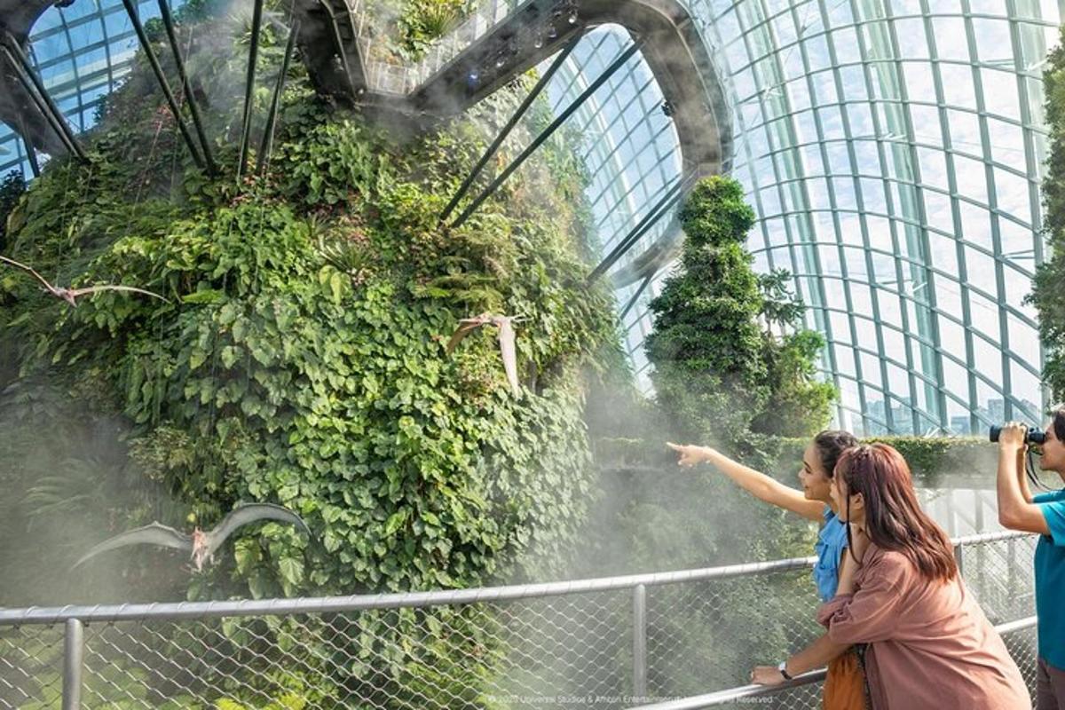 two women are pointing at a plant in a building