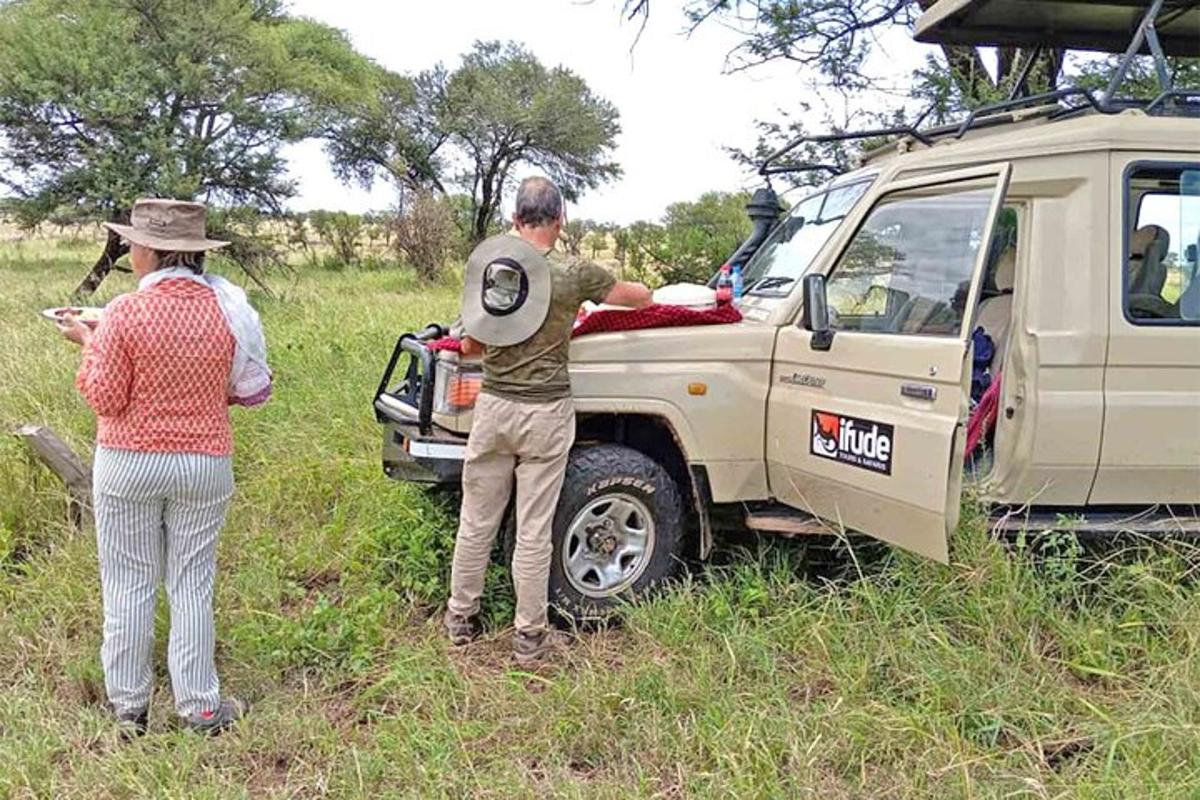 a couple of people standing next to a truck