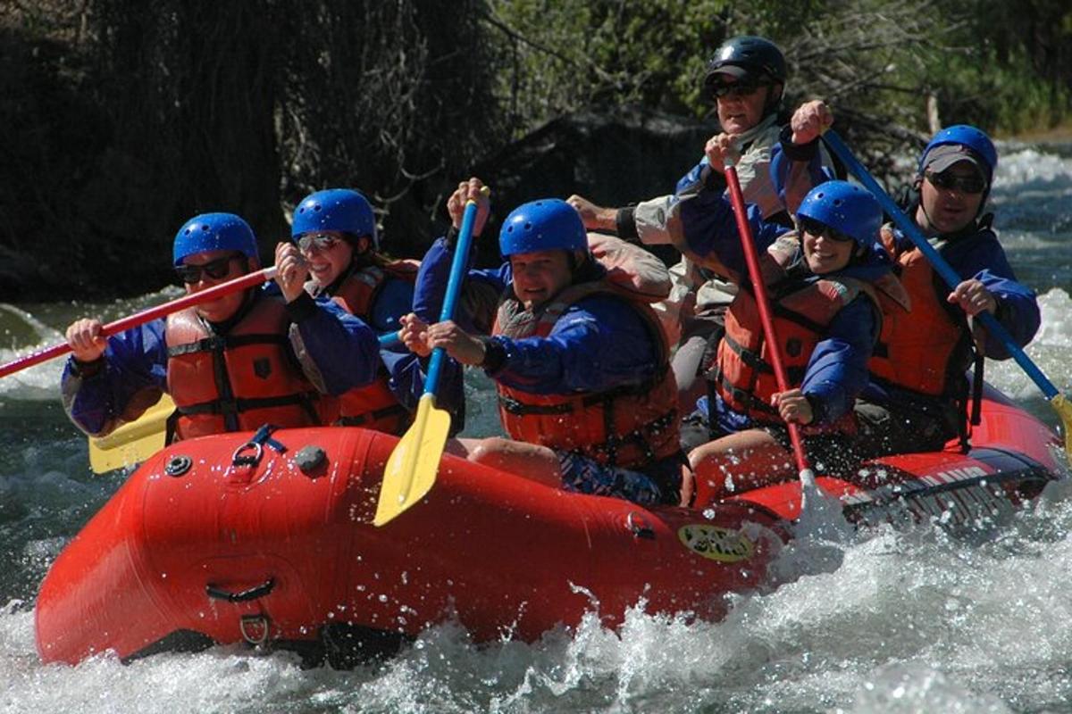 a group of people in a raft on a river