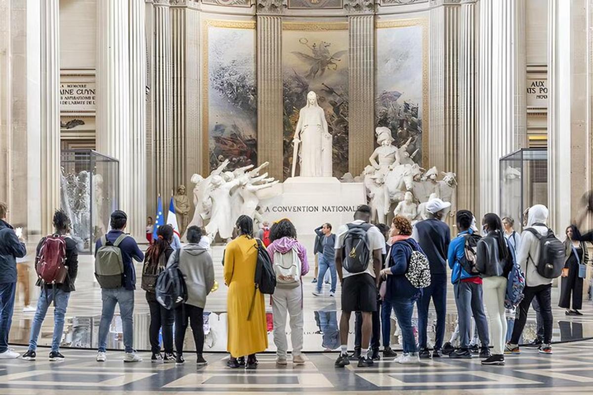 a group of people standing in front of a statue