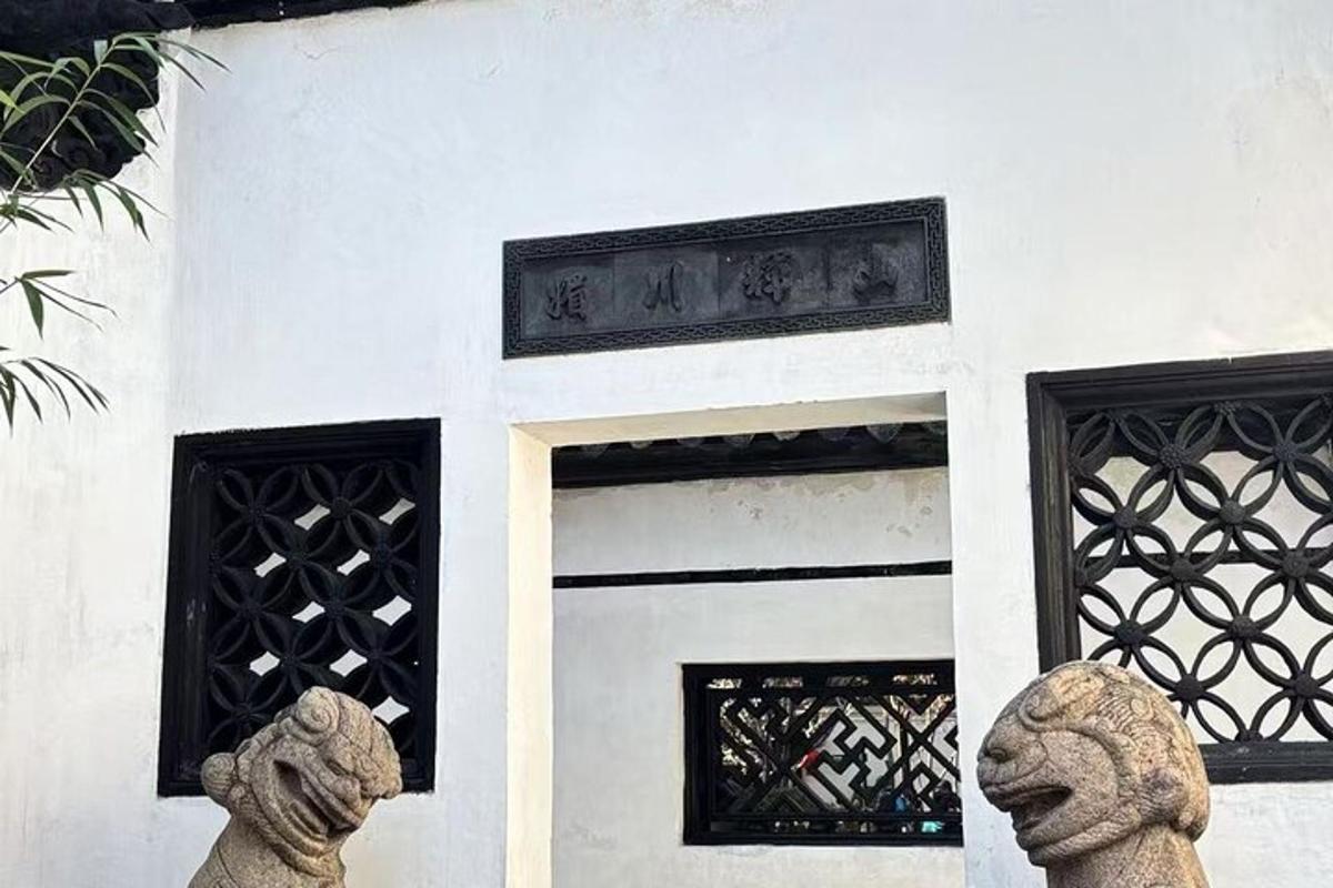 two statues in front of a building with windows