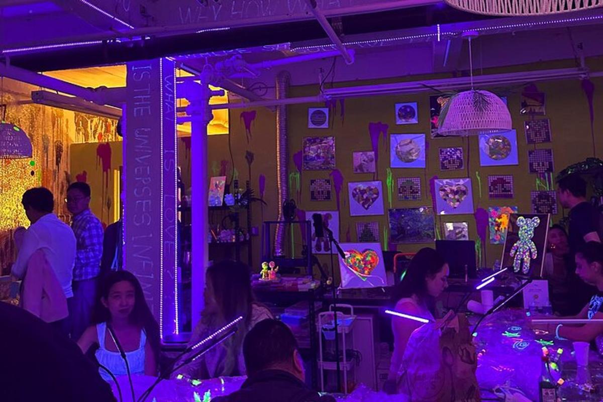 a group of people in a room with purple lights