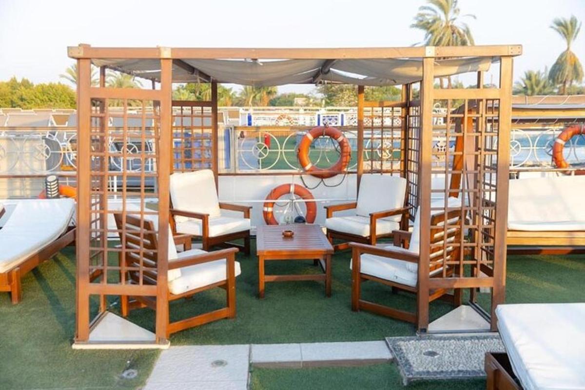 a deck with chairs and tables on a boat