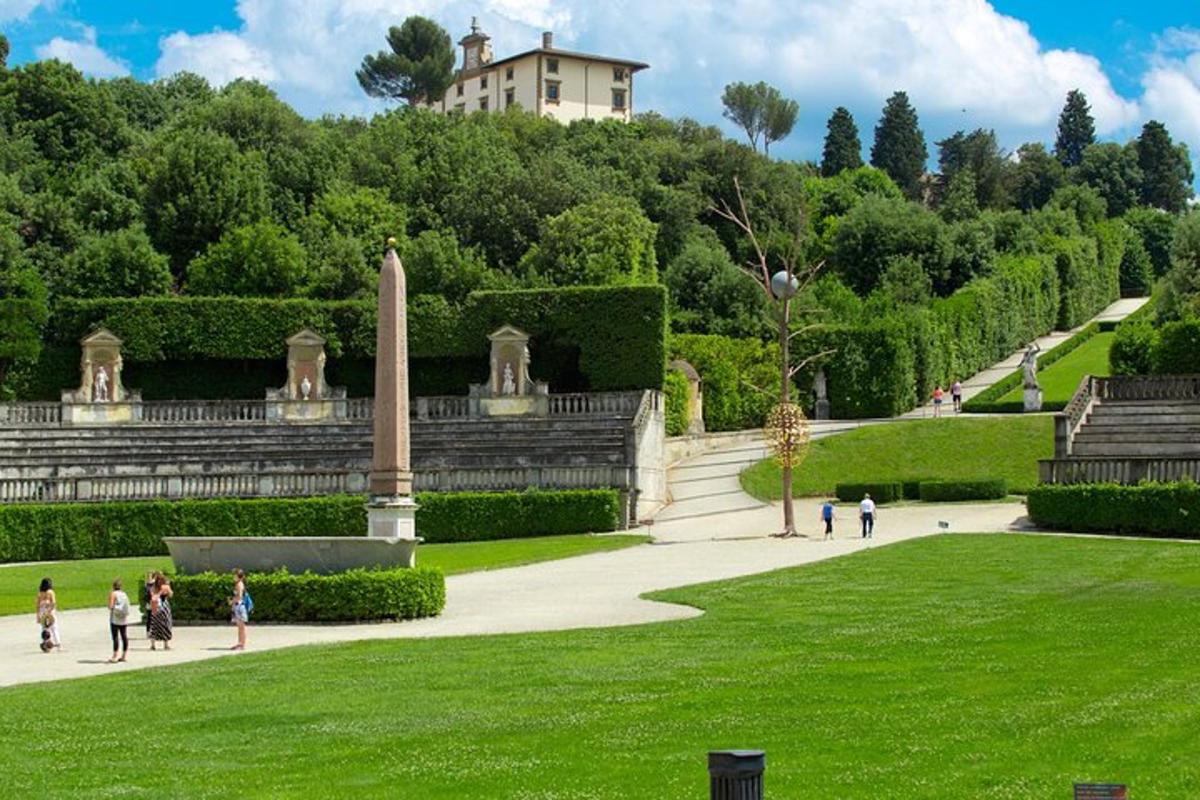 people walking around a park with a building in the background