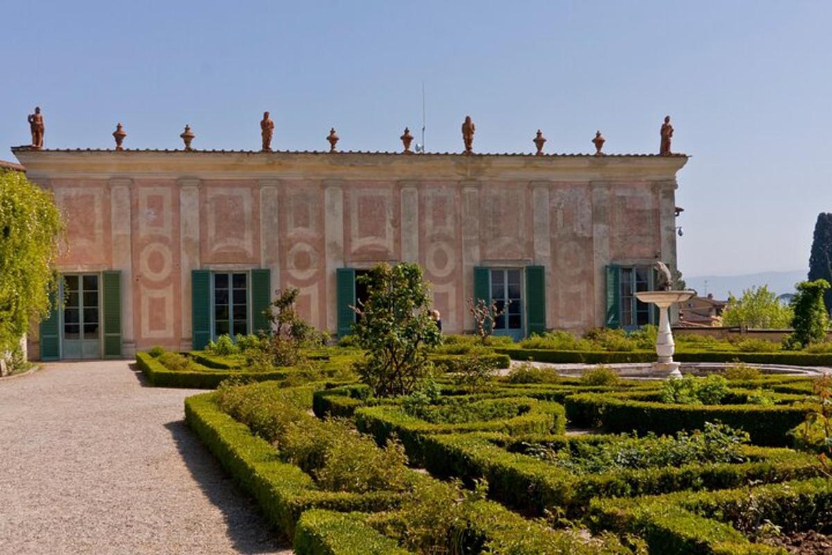 an old building with a garden in front of it