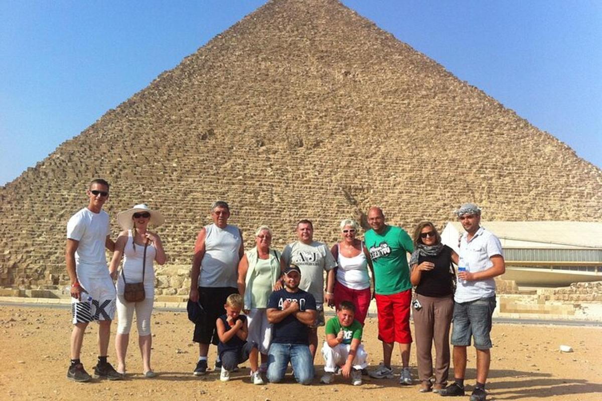a group of people standing in front of a pyramid