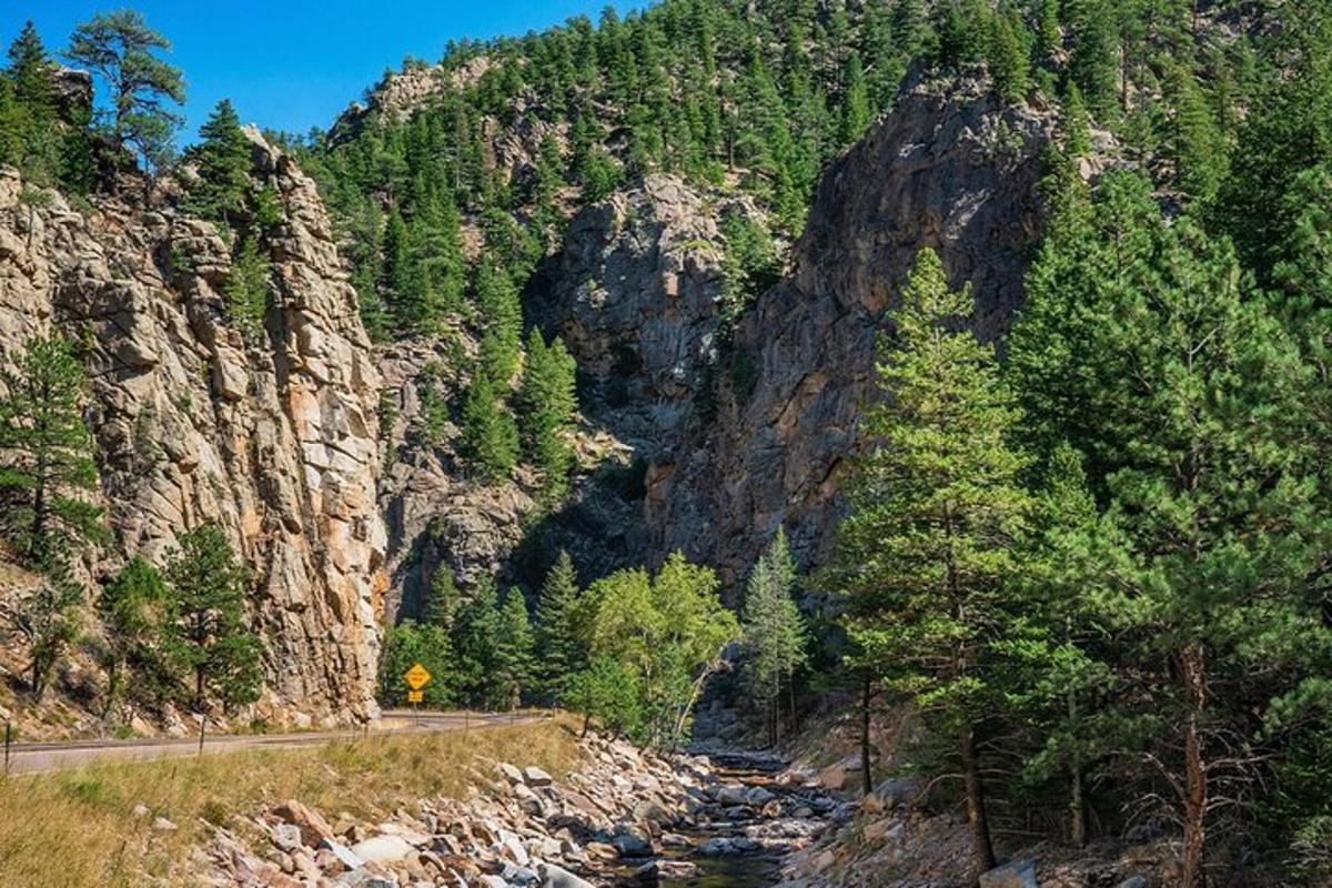 a mountain with a road next to a river