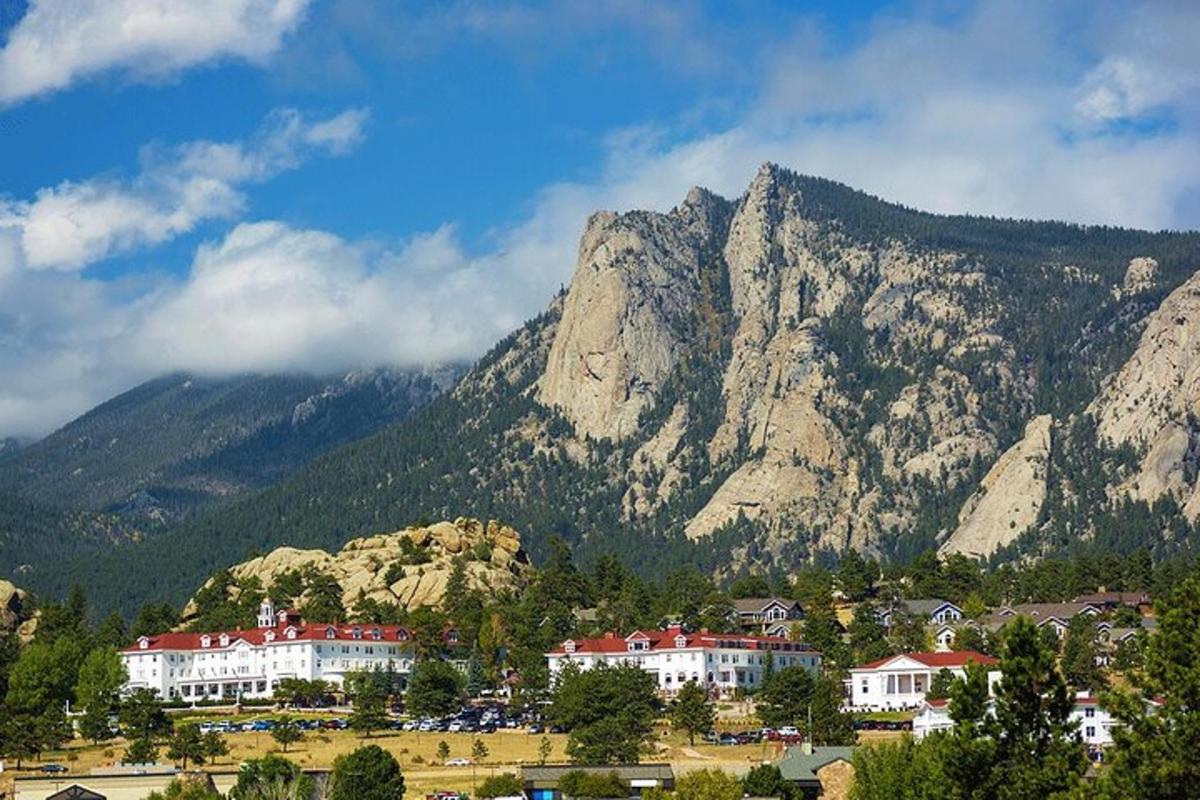 a town in front of a mountain with houses