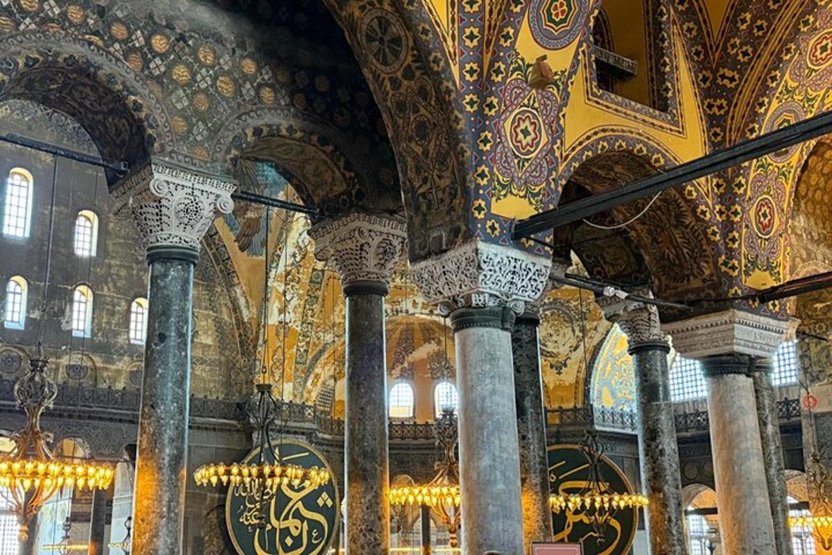 a large room with ornate ceilings and columns in a mosque