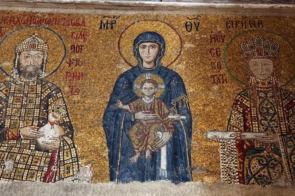 a mosaic of three people with a child on a wall