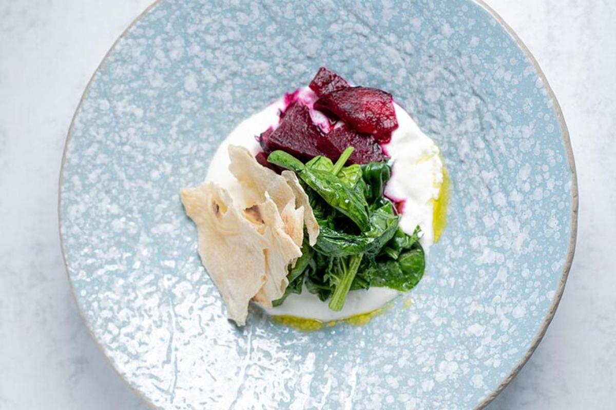a blue plate with a dessert with greens on it