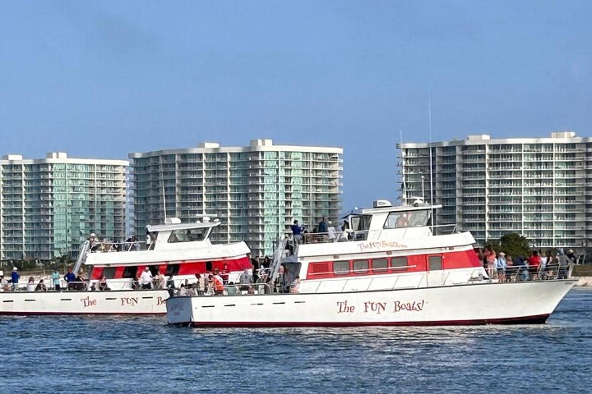 two boats in the water in front of tall buildings