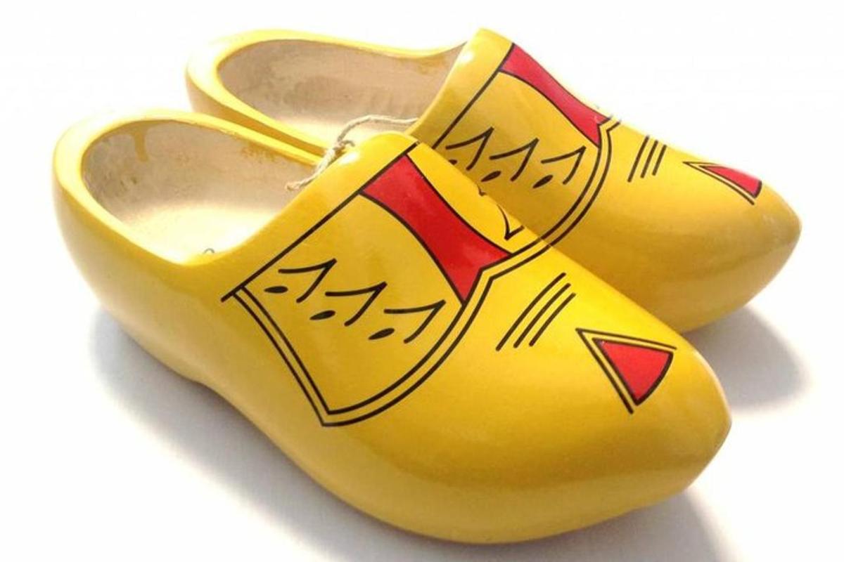 a pair of yellow shoes with writing on them