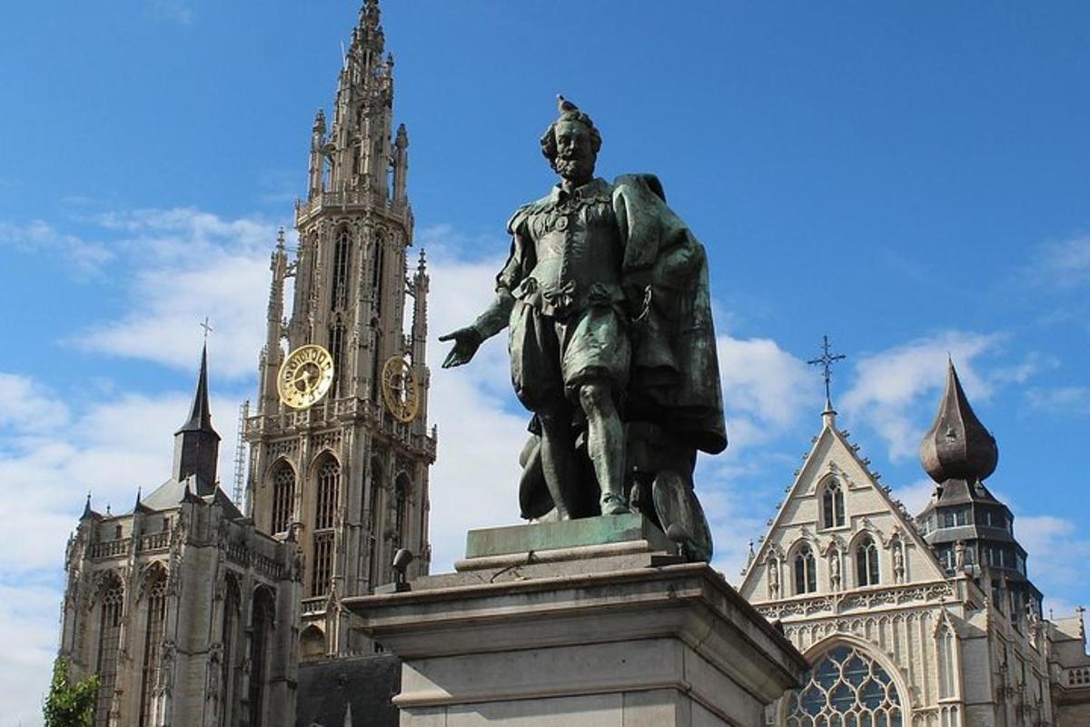 una estatua frente a un edificio con una torre de reloj