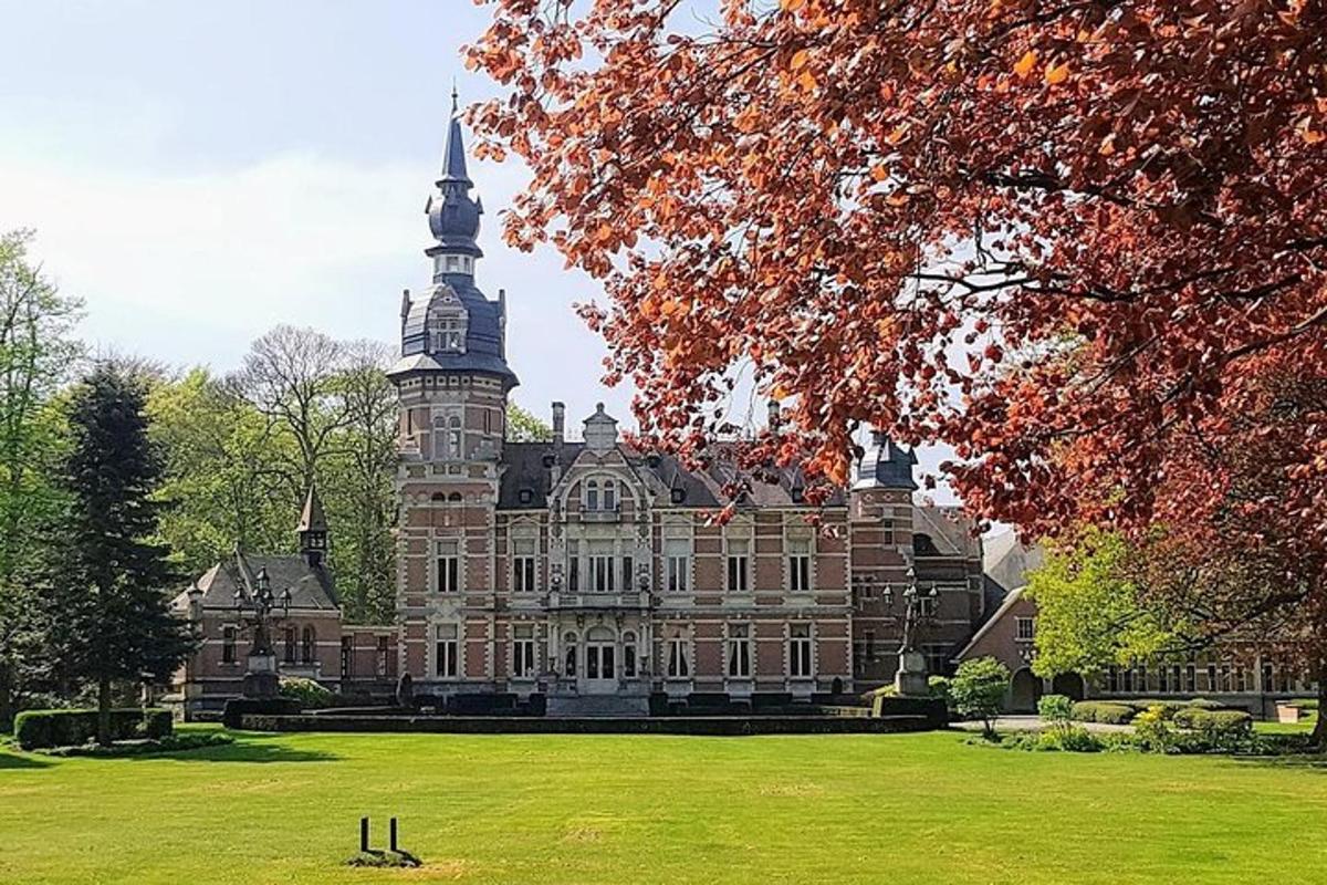 a large building with a tower on top of a field