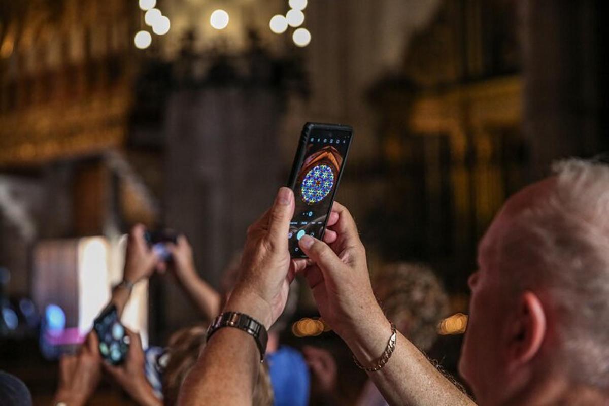 a group of people taking pictures with their cell phones
