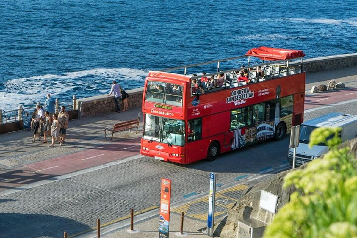 ein roter Doppeldeckerbus fährt eine Straße entlang