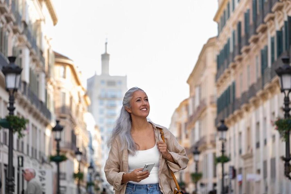 a woman walking down a city street with her cell phone