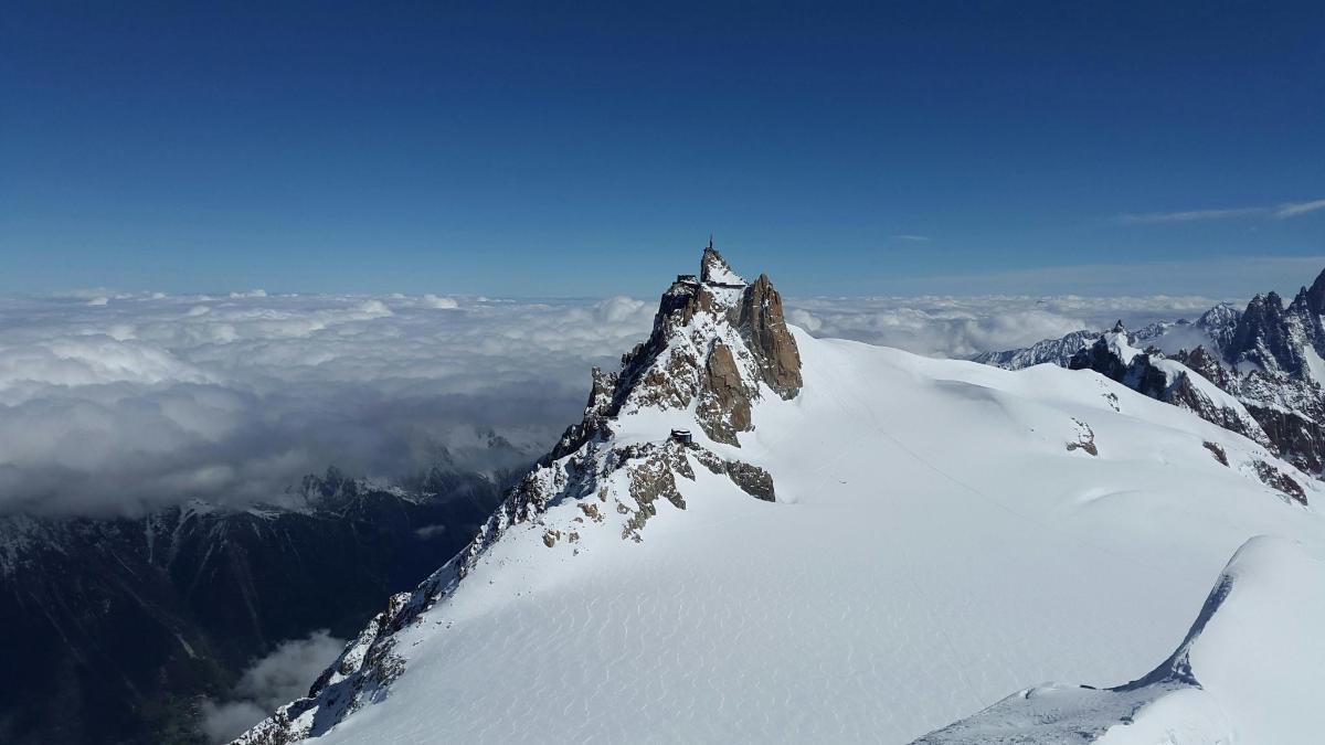 a person on top of a mountain in the snow