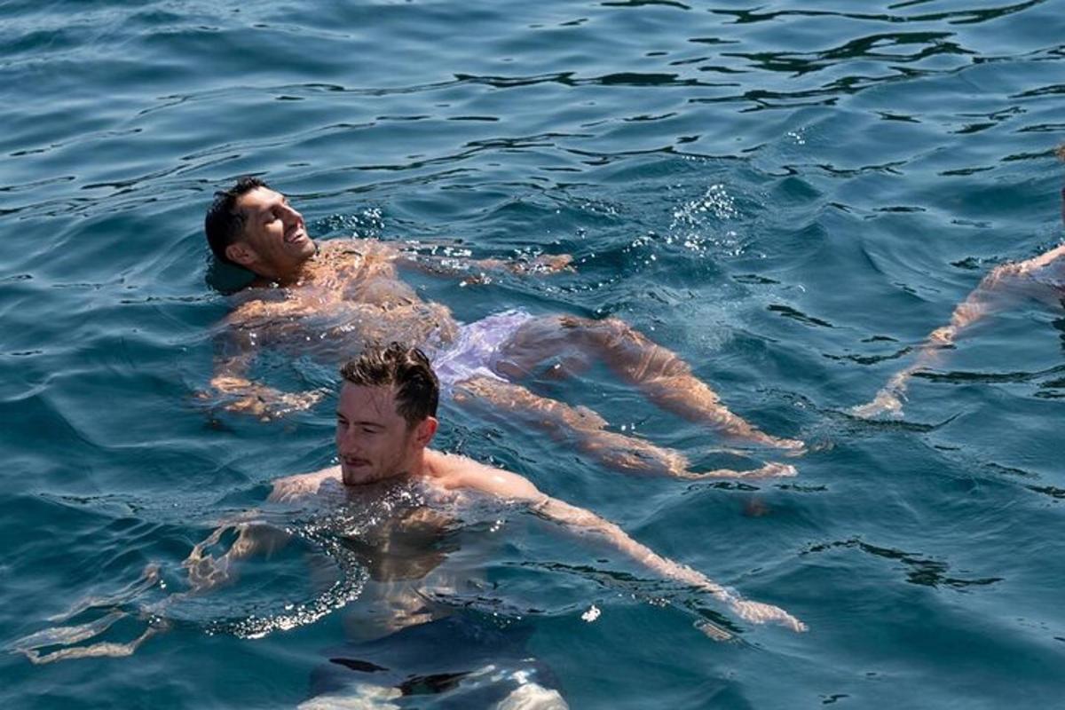 a group of men swimming in the water