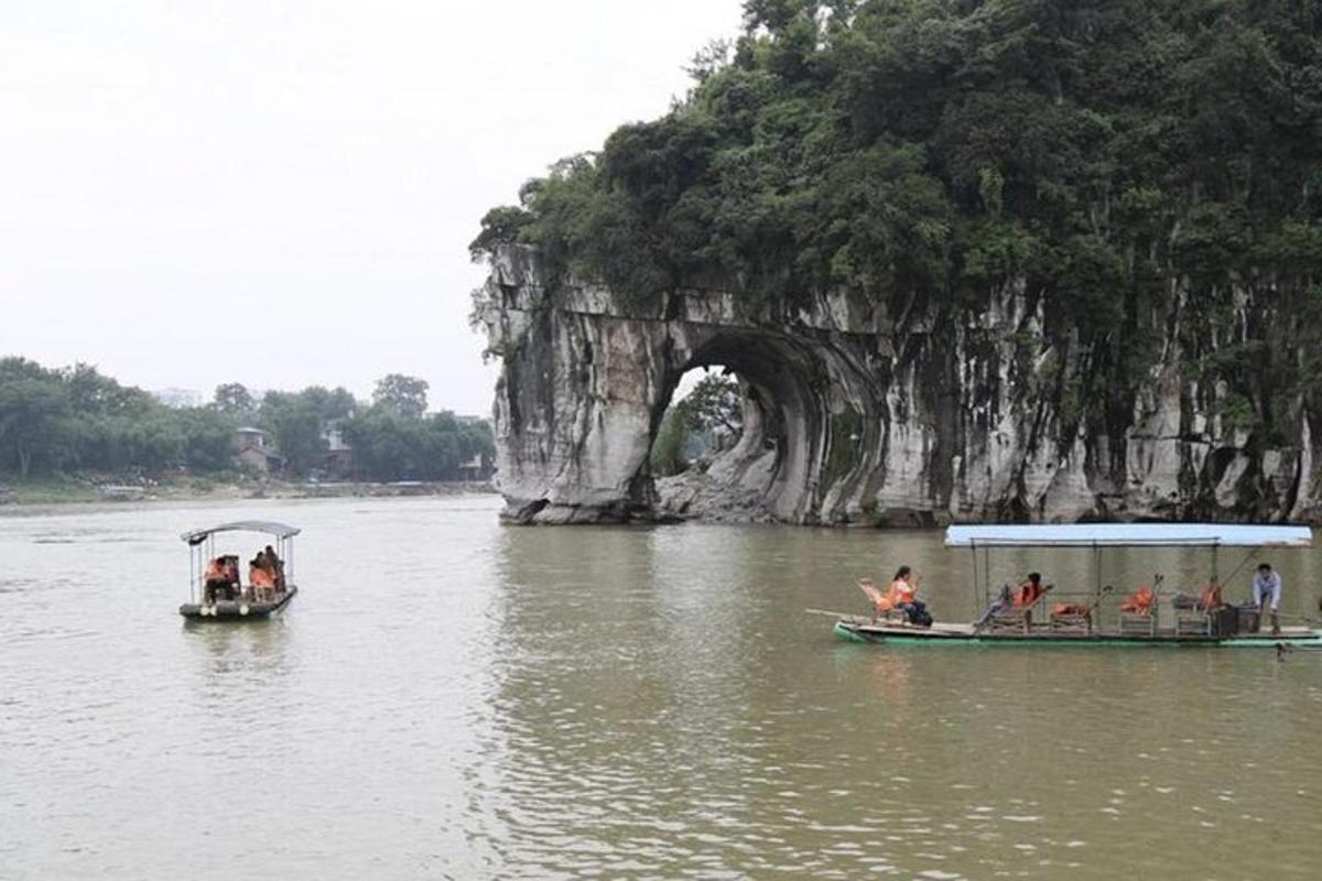 two boats in the water in front of a bridge