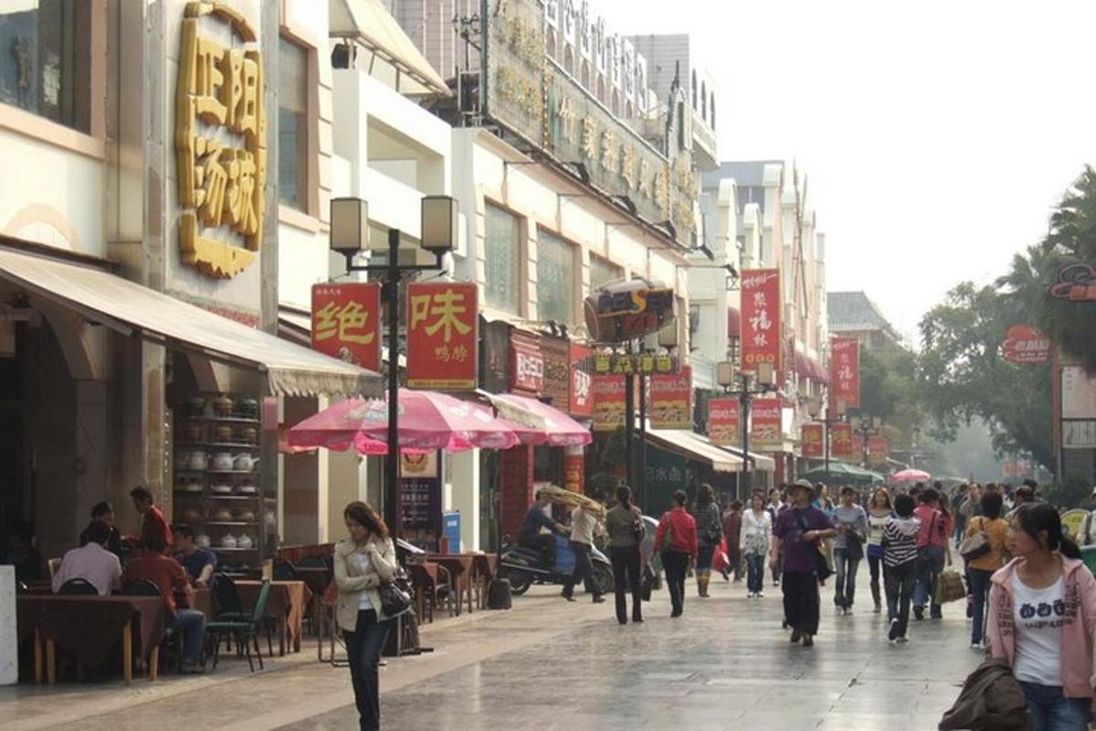 a group of people walking down a busy city street
