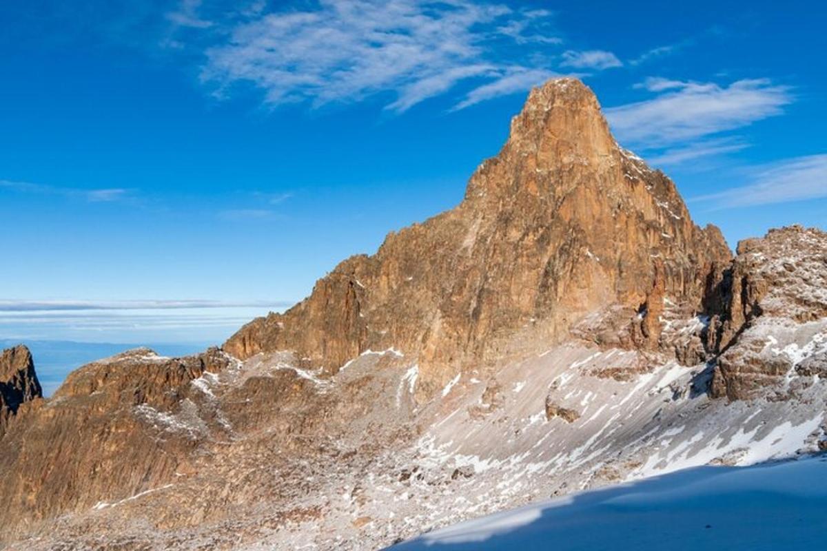 stórt grýtt fjall með snjó á því