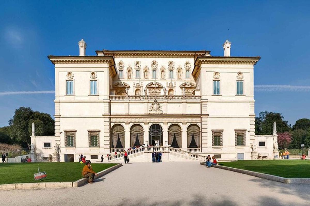 a large white building with people standing outside of it
