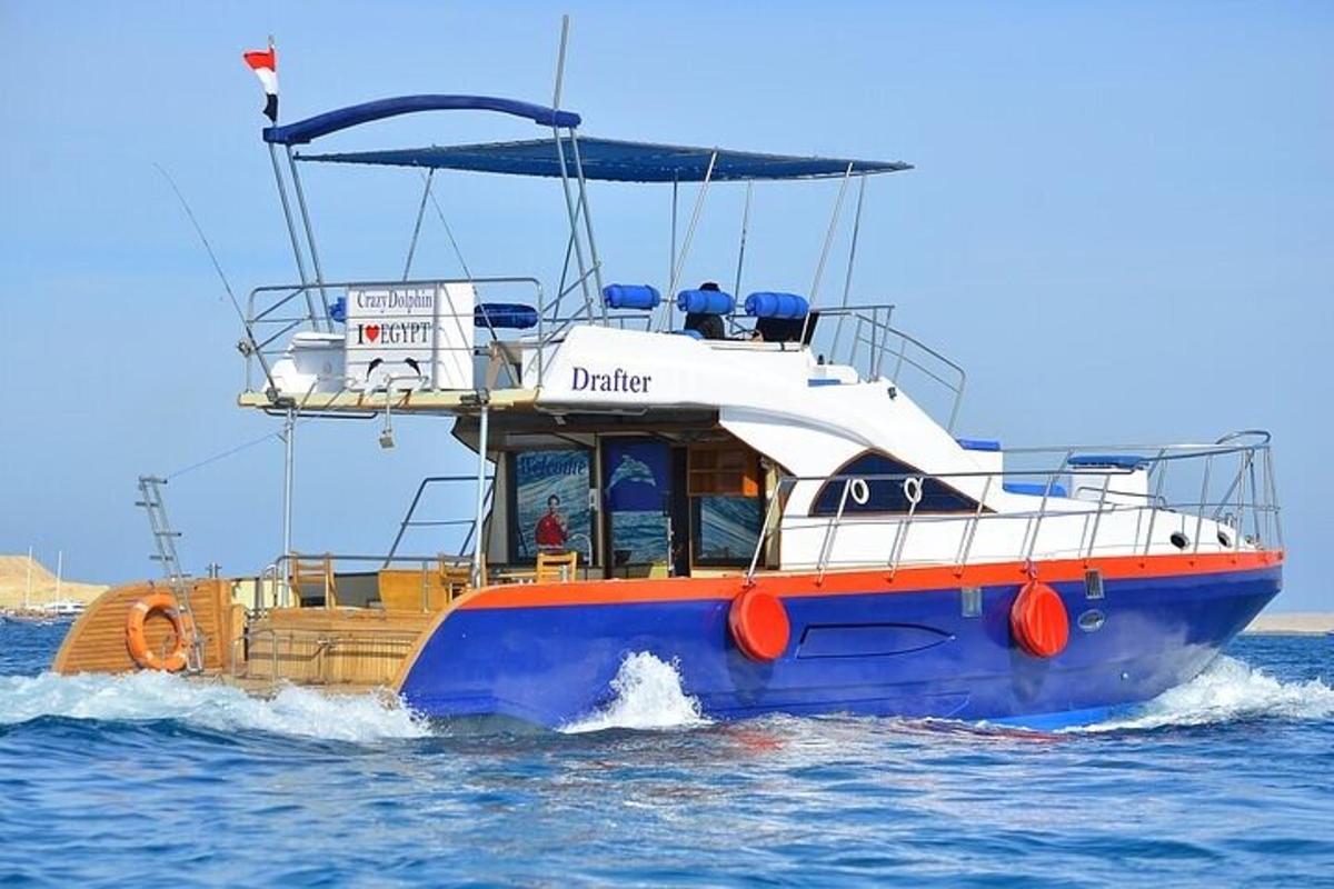 a blue and orange boat in the water