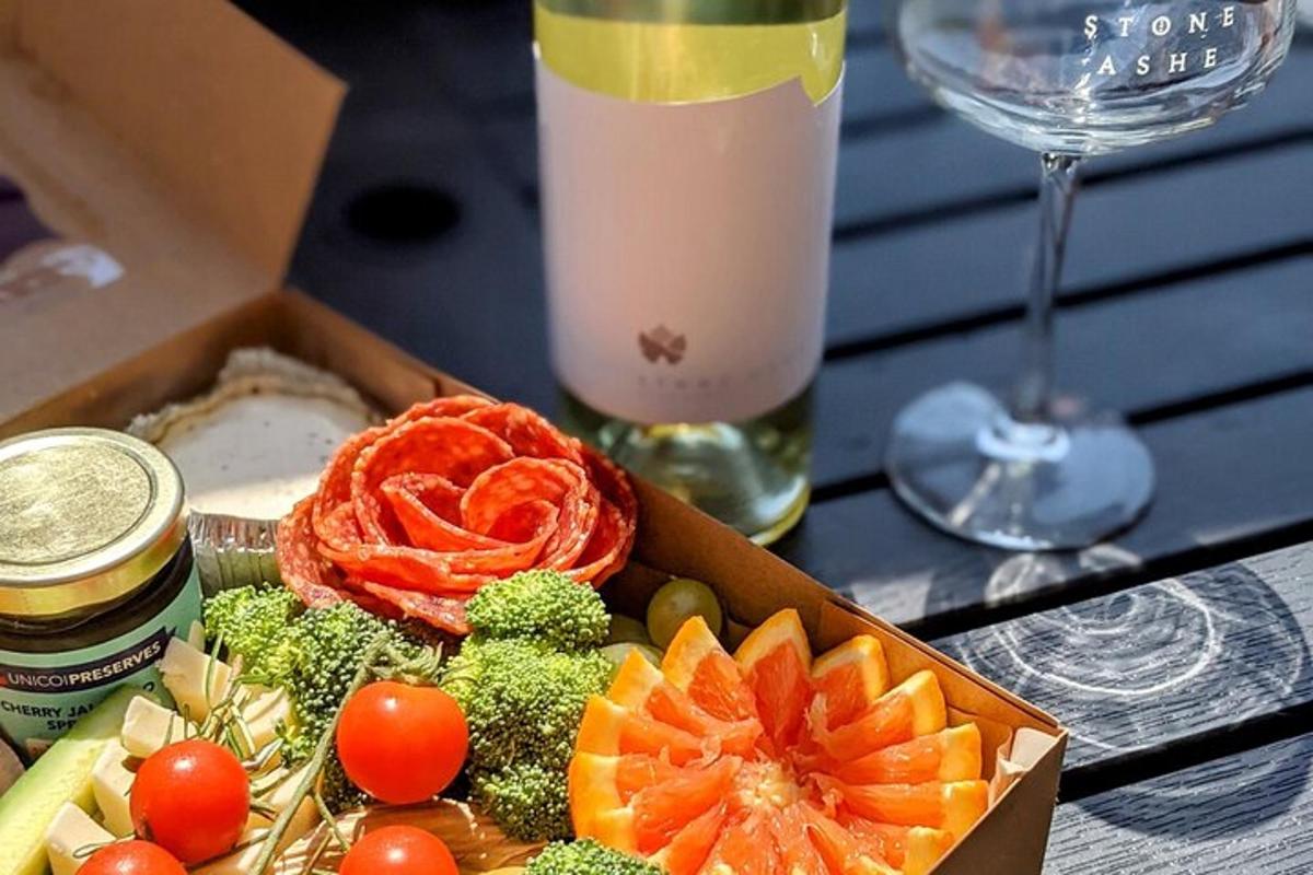 a box filled with vegetables and a glass of wine