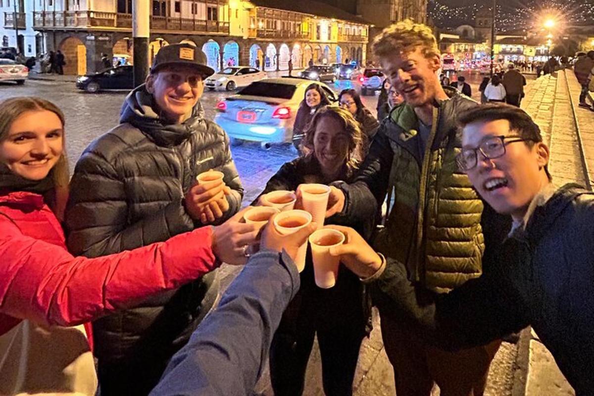 a group of people are holding up paper cups