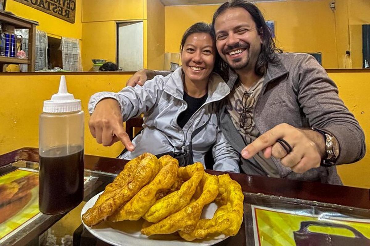 a man and a woman standing next to a plate of food