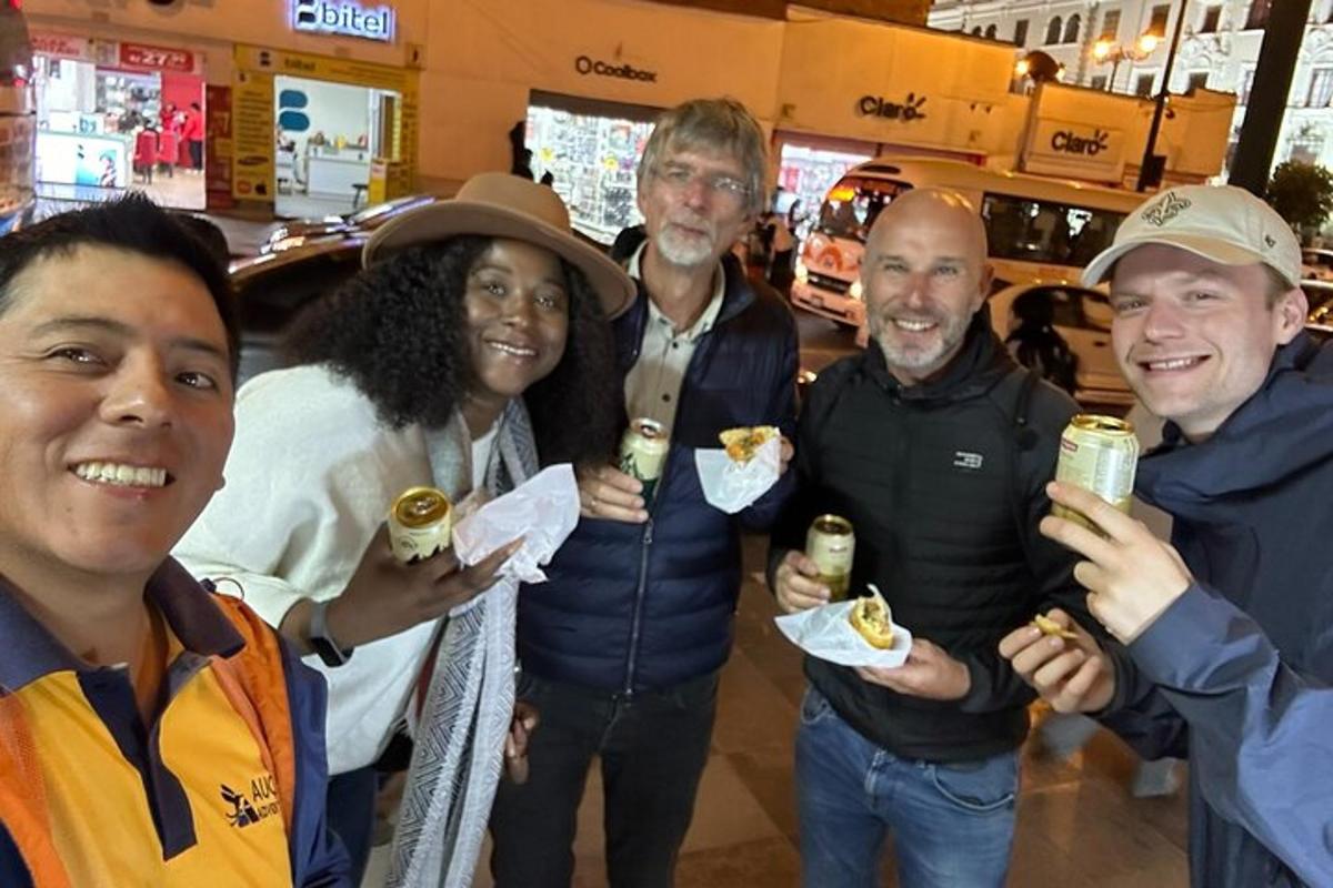 a group of people posing for a picture with food
