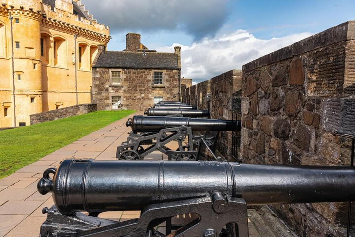 a row of cannons on the side of a castle