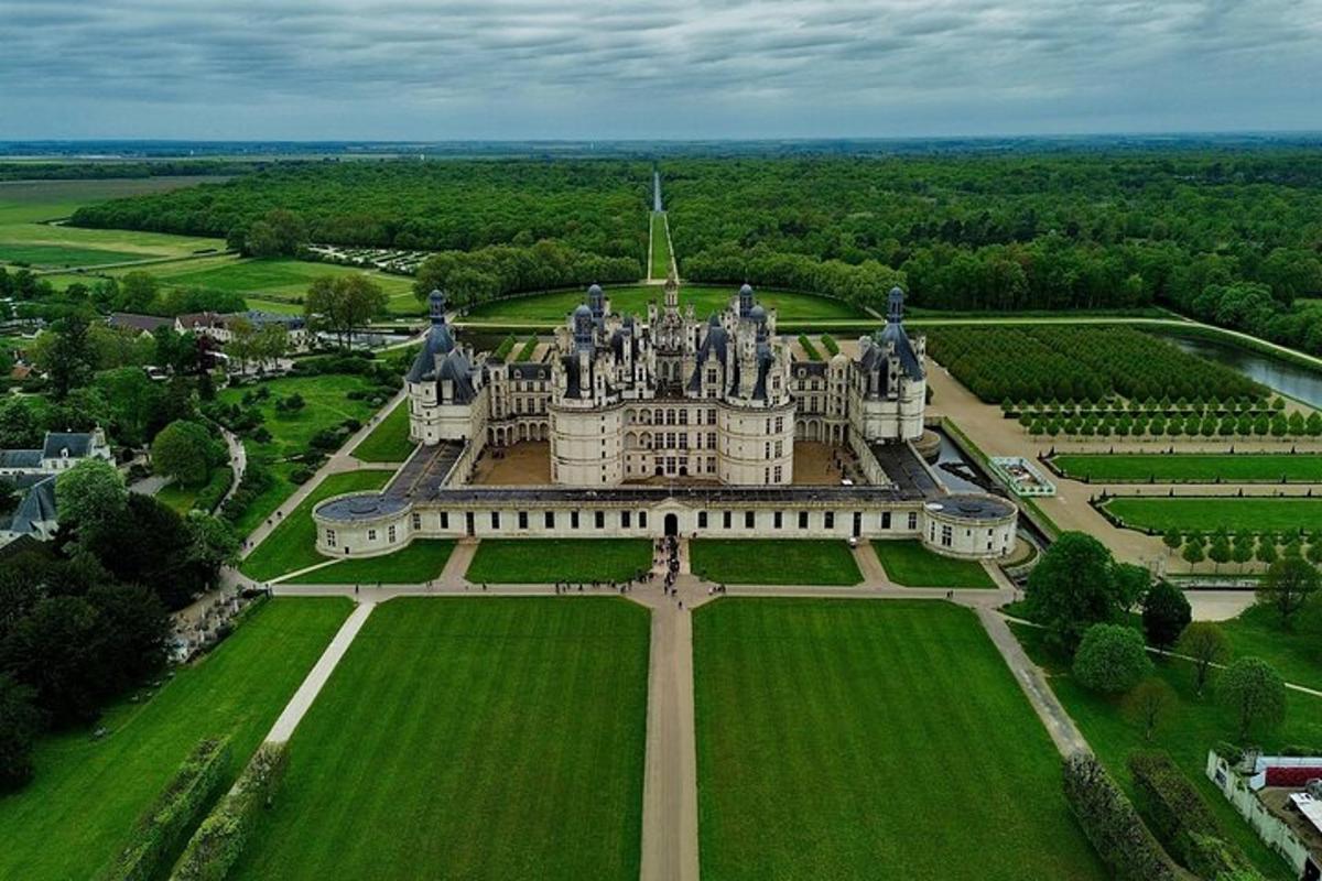 an aerial view of a castle in a field