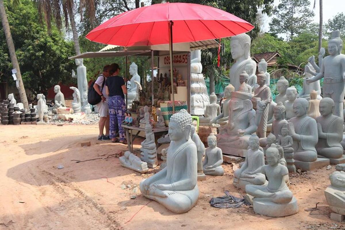un gruppo di statue bianche con un ombrello rosso