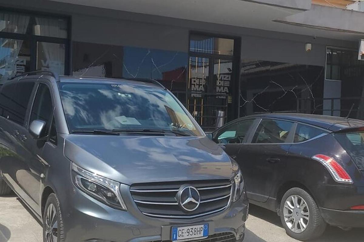 two cars parked next to each other in a parking lot