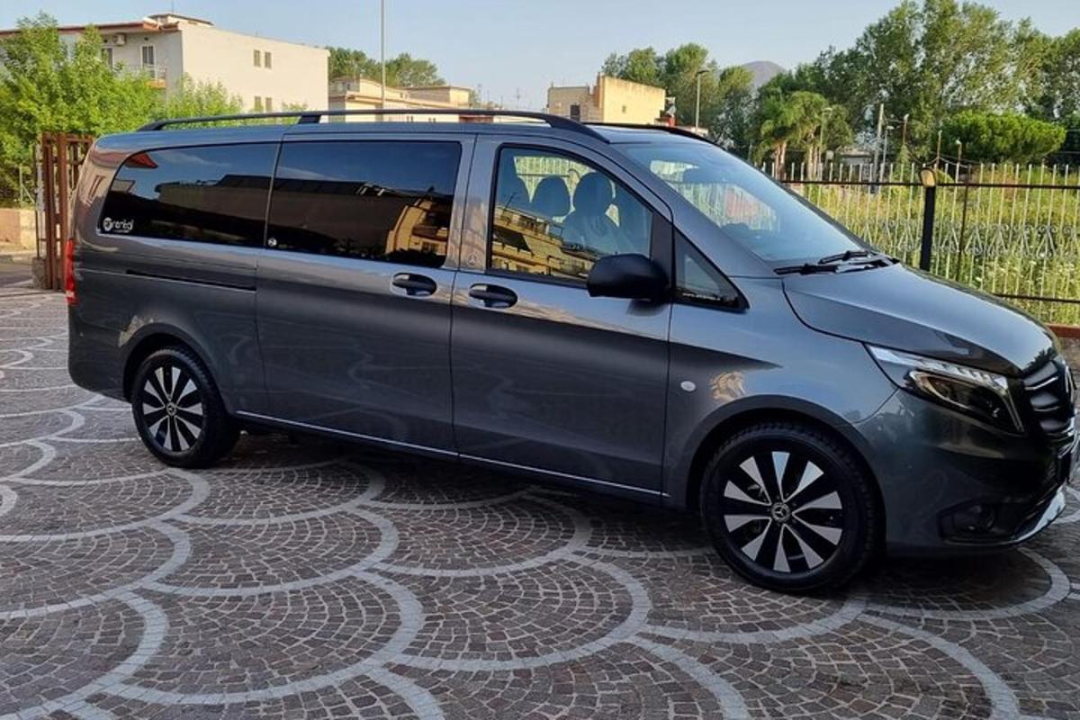 a gray minivan parked on a street