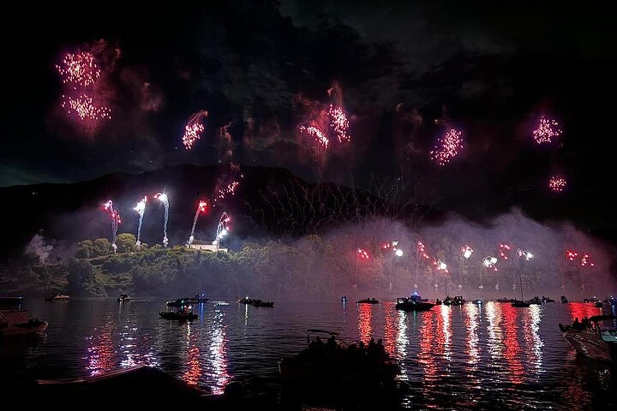 a fireworks display over a body of water with boats