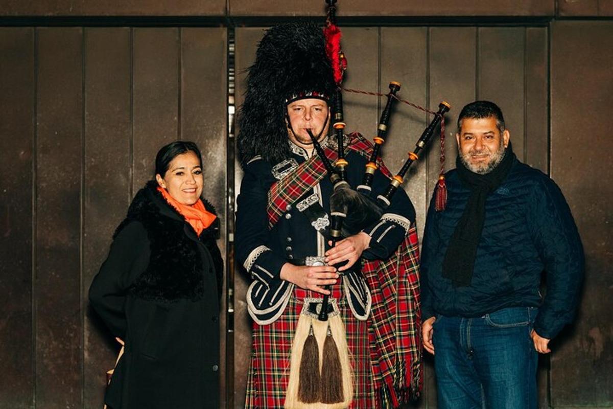 a man in a kilt standing next to a woman